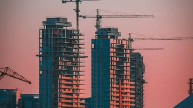 gray building crane photo during sunset